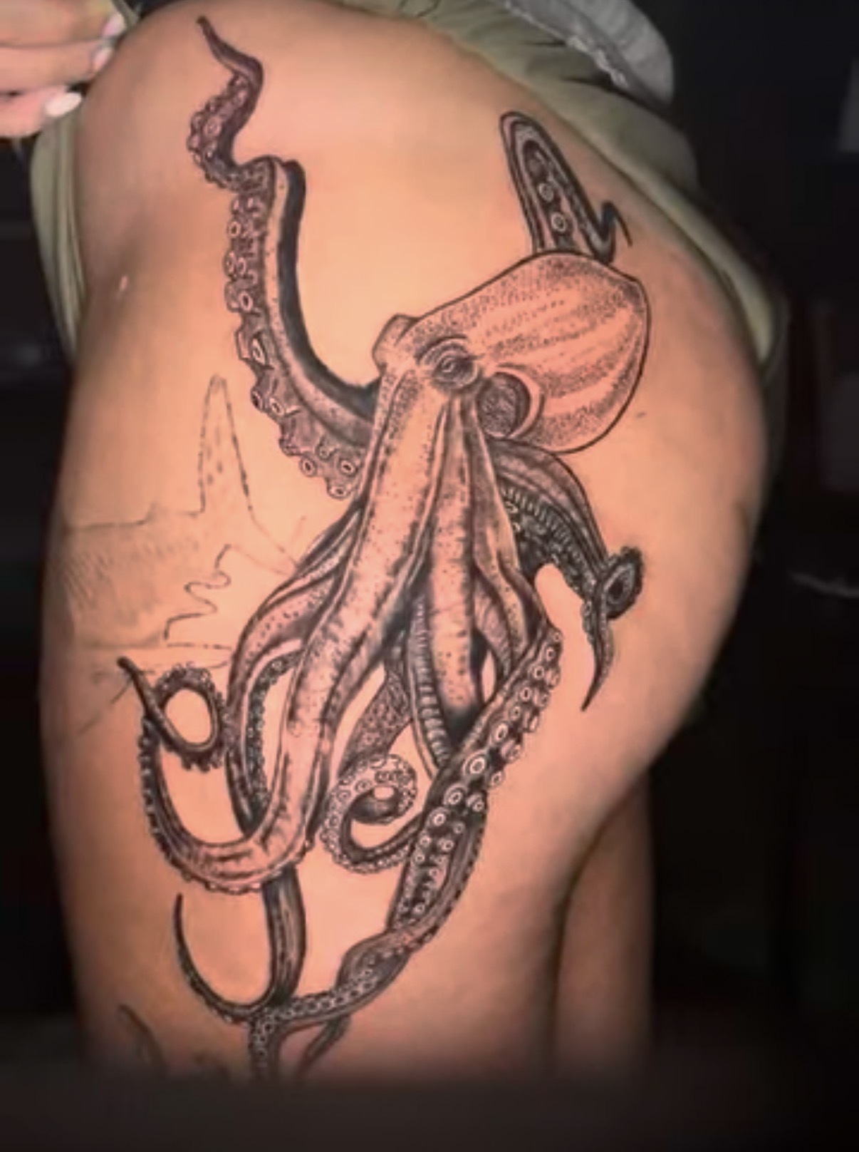 Large black and grey octopus tattoo by Craig Thomas covering a hip and thigh